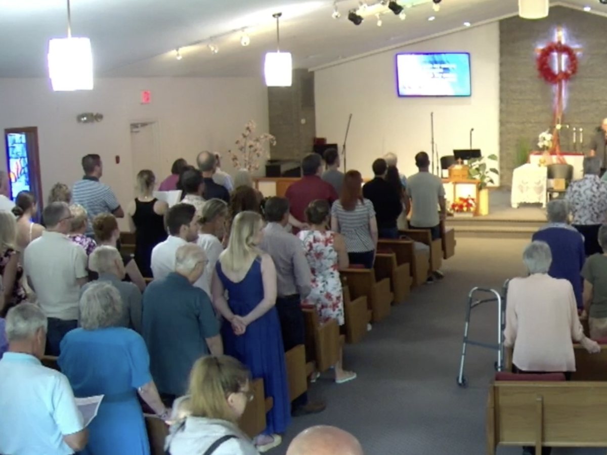 The New Bethel congregation worshiping together in the sanctuary