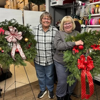 Friends holding the wreaths they made together